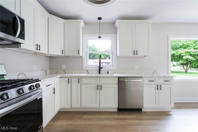 351 Cranberry Run, Boardman, OH 44512 - kitchen featuring stainless steel appliances, a sink, white cabinetry, and healthy amount of natural light