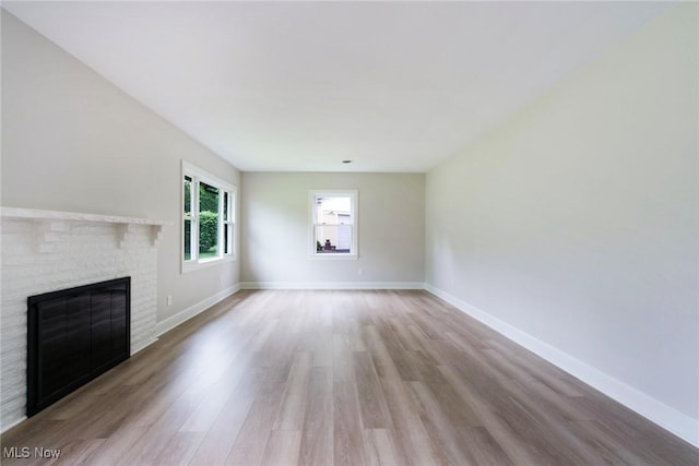 351 Cranberry Run, Boardman, OH 44512 - unfurnished living room with wood finished floors, a brick fireplace, and baseboards