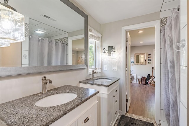 30699 Gates Mills Blvd, Pepper Pike, OH 44124 - full bathroom with two vanities, a shower with shower curtain, wood finished floors, and recessed lighting