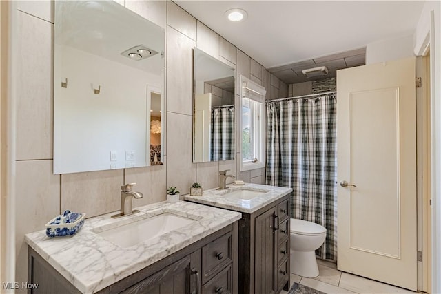 30699 Gates Mills Blvd, Pepper Pike, OH 44124 - bathroom with two vanities, toilet, tile patterned flooring, tile walls, and a shower with curtain
