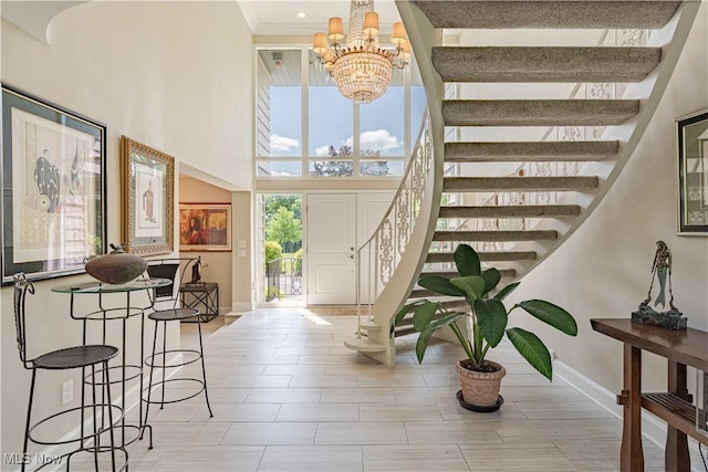 30699 Gates Mills Blvd, Pepper Pike, OH 44124 - foyer featuring a chandelier, stairs, a high ceiling, baseboards, and crown molding
