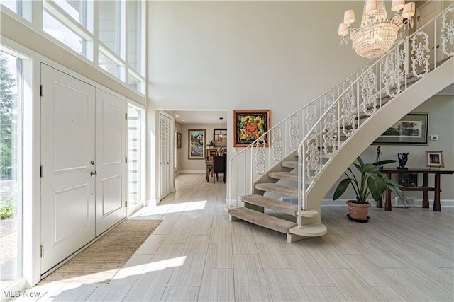 30699 Gates Mills Blvd, Pepper Pike, OH 44124 - entrance foyer featuring stairway, a towering ceiling, a chandelier, and healthy amount of natural light