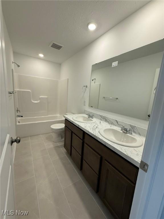 23669 Wallys Way, Columbia Station, OH 44028 - bathroom featuring double vanity, toilet, shower / tub combination, a textured ceiling, and tile patterned floors