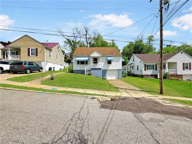 121 Valley Way, Weirton, WV 26062 - bungalow-style home with driveway, an attached garage, a front yard, and a residential view