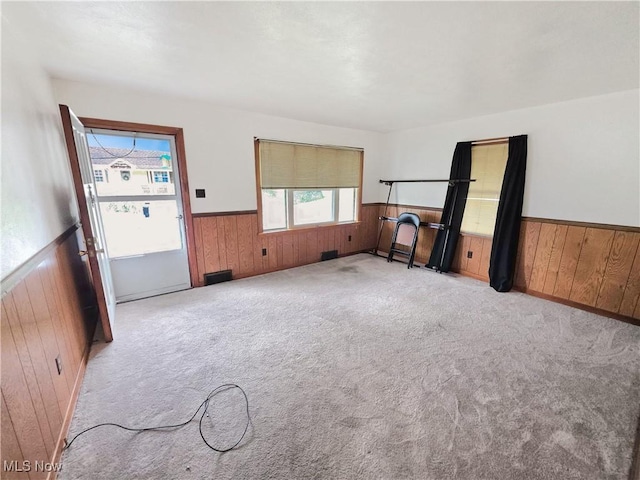 121 Valley Way, Weirton, WV 26062 - unfurnished living room with a wainscoted wall, wood walls, and carpet