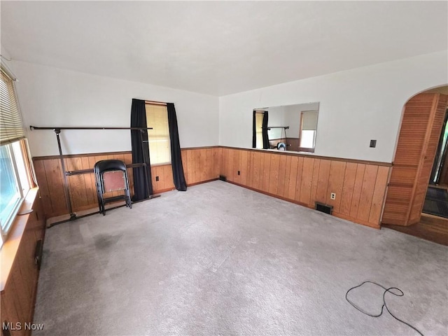 121 Valley Way, Weirton, WV 26062 - empty room with wainscoting, wooden walls, arched walkways, and light carpet