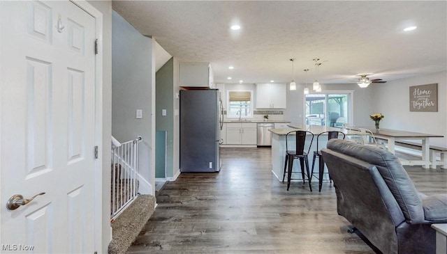 1379 S Polen Ave, Mogadore, OH 44260 - kitchen featuring stainless steel appliances, open floor plan, a sink, a breakfast bar, and white cabinetry