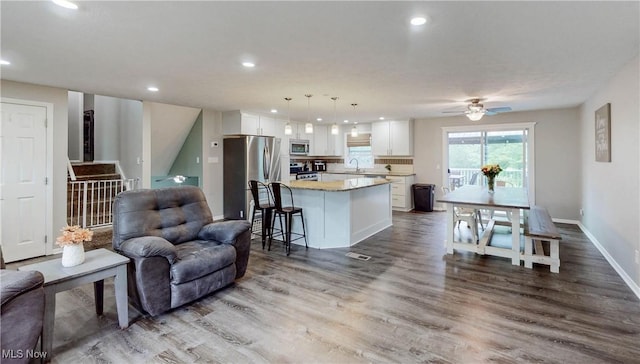 1379 S Polen Ave, Mogadore, OH 44260 - living room featuring wood finished floors, a ceiling fan, recessed lighting, and baseboards
