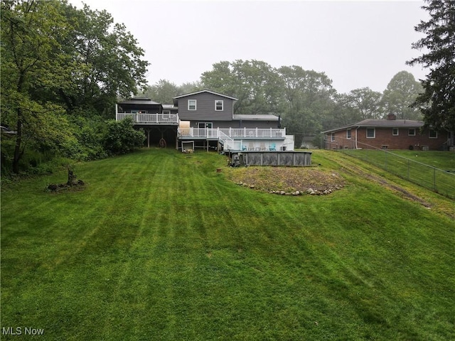 1379 S Polen Ave, Mogadore, OH 44260 - rear view of property with an outdoor pool and a wooden deck