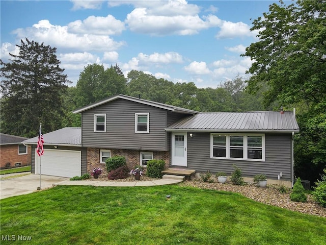 1379 S Polen Ave, Mogadore, OH 44260 - tri-level home with a garage, a front lawn, driveway, and brick siding
