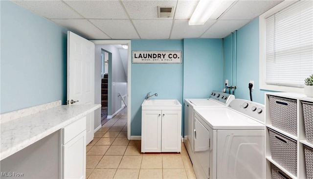 1379 S Polen Ave, Mogadore, OH 44260 - laundry area featuring washer and dryer, cabinet space, and light tile patterned floors