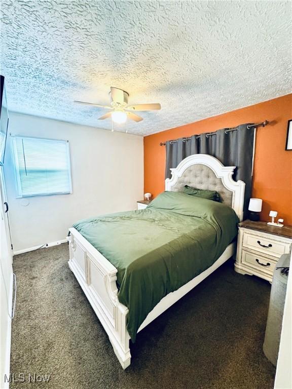156 N Beverly, Austintown, OH 44515 - bedroom with dark carpet, a textured ceiling, and ceiling fan
