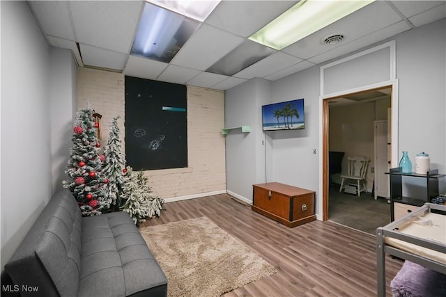 38 E Main St, Shelby, OH 44875 - living area with a paneled ceiling, wood finished floors, and baseboards