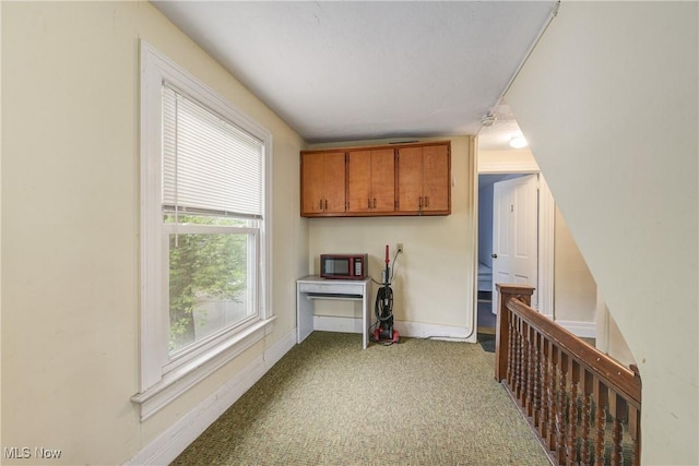 44 W Vine St, Oberlin, OH 44074 - kitchen with carpet flooring, brown cabinetry, and baseboards