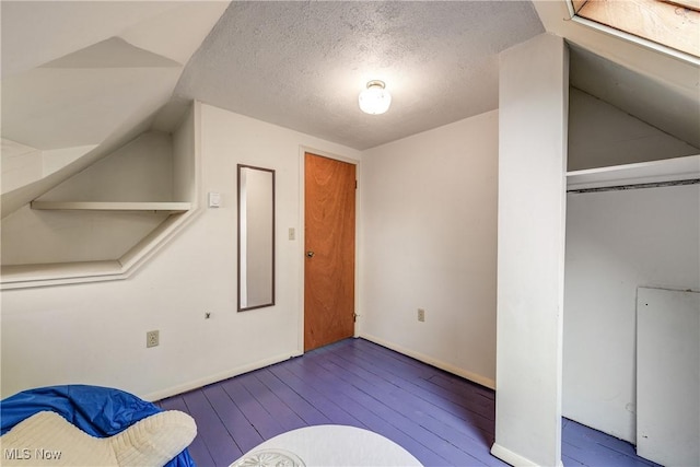 44 W Vine St, Oberlin, OH 44074 - foyer entrance with wood-type flooring, baseboards, a textured ceiling, and vaulted ceiling