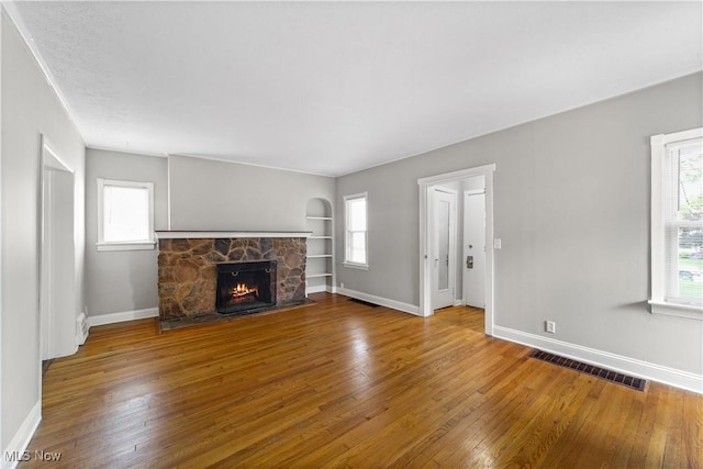 5688 Shawnee Dr, Lyndhurst, OH 44124 - unfurnished living room featuring wood-type flooring, a fireplace, and baseboards