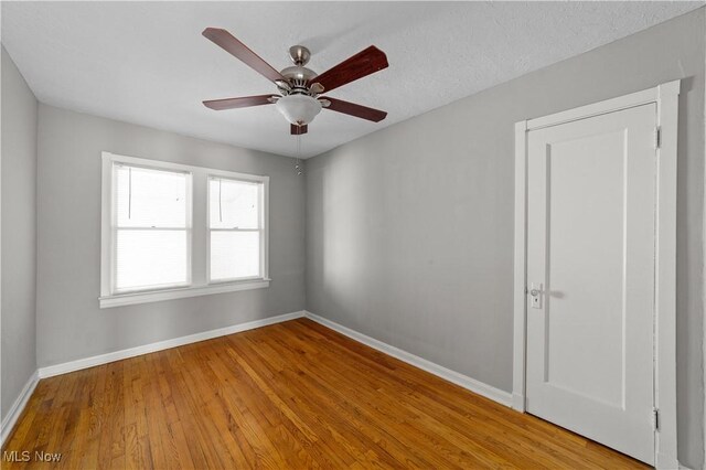 5688 Shawnee Dr, Lyndhurst, OH 44124 - unfurnished room with baseboards, wood finished floors, and a ceiling fan