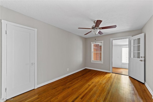 5688 Shawnee Dr, Lyndhurst, OH 44124 - spare room featuring wood-type flooring, baseboards, ceiling fan, and a textured ceiling
