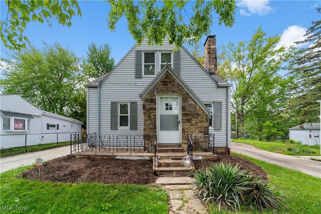 5688 Shawnee Dr, Lyndhurst, OH 44124 - tudor house with stone siding and a chimney