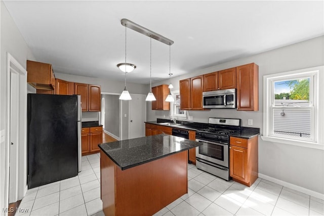 5688 Shawnee Dr, Lyndhurst, OH 44124 - kitchen with appliances with stainless steel finishes, a center island, baseboards, decorative light fixtures, and brown cabinets