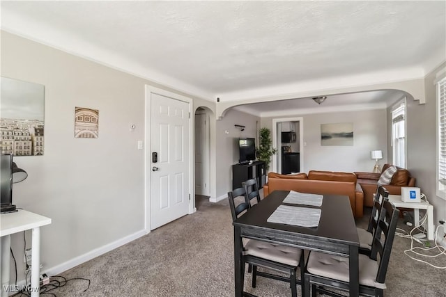 13641 Cedar Rd, University Heights, OH 44118 - dining room with arched walkways, carpet flooring, and baseboards