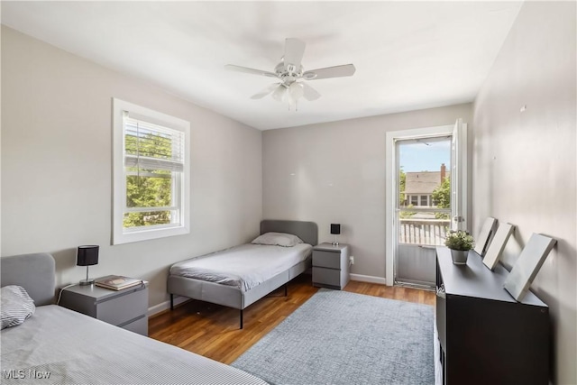 13641 Cedar Rd, University Heights, OH 44118 - bedroom with multiple windows, access to outside, wood finished floors, and baseboards