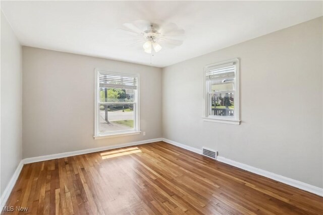 13641 Cedar Rd, University Heights, OH 44118 - empty room featuring wood finished floors, baseboards, and ceiling fan