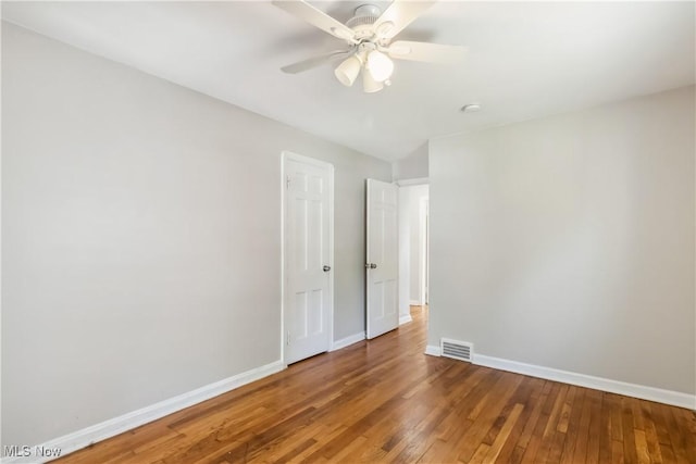 13641 Cedar Rd, University Heights, OH 44118 - spare room with baseboards, hardwood / wood-style floors, and a ceiling fan
