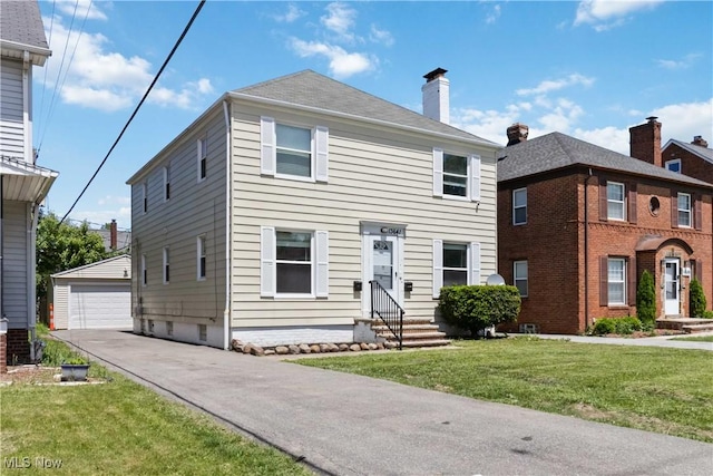 13641 Cedar Rd, University Heights, OH 44118 - view of front of property with entry steps, an outdoor structure, a detached garage, a front lawn, and a chimney