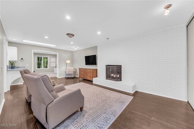 17404 Falling Water Rd, Strongsville, OH 44136 - living room featuring brick wall, wood finished floors, baseboards, recessed lighting, and a fireplace