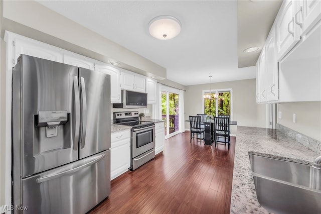 17404 Falling Water Rd, Strongsville, OH 44136 - kitchen with appliances with stainless steel finishes, a sink, dark wood-style floors, a chandelier, and white cabinetry