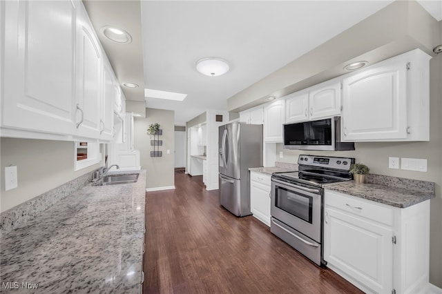 17404 Falling Water Rd, Strongsville, OH 44136 - kitchen featuring stainless steel appliances, a sink, light stone counters, dark wood-style flooring, and recessed lighting