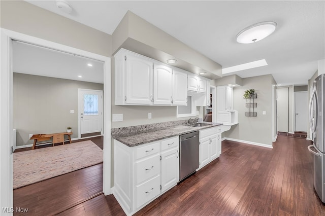 17404 Falling Water Rd, Strongsville, OH 44136 - kitchen featuring stainless steel appliances, a sink, light stone counters, dark wood-style floors, and white cabinetry