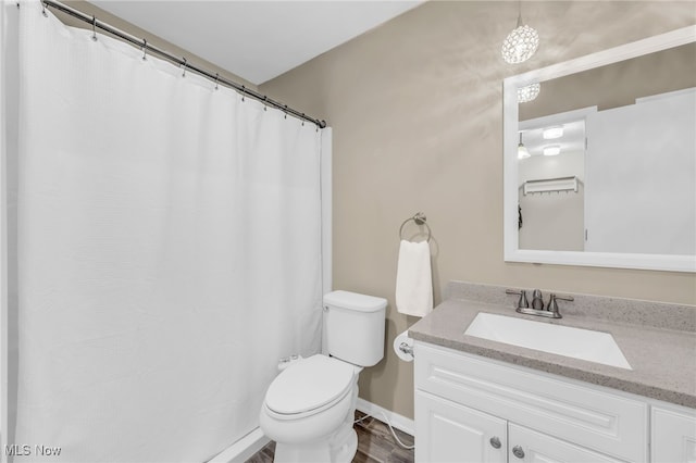 17404 Falling Water Rd, Strongsville, OH 44136 - bathroom with vanity, toilet, wood finished floors, and baseboards
