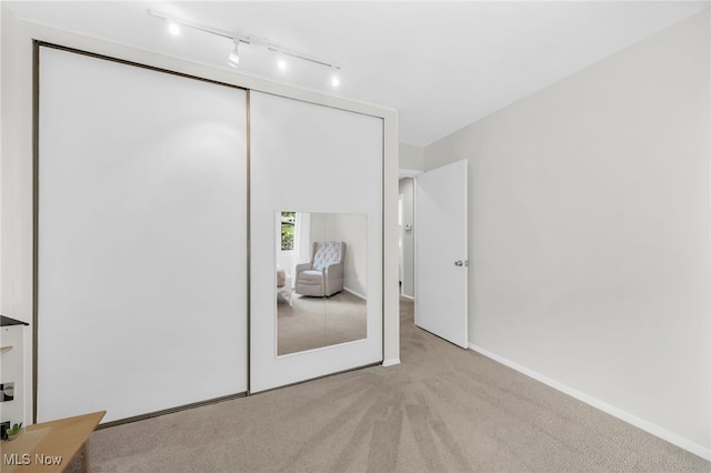 17404 Falling Water Rd, Strongsville, OH 44136 - bedroom featuring carpet, a closet, track lighting, and baseboards
