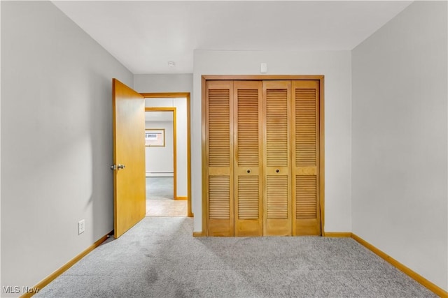 10701 Mountview Ave, Garfield Heights, OH 44125 - unfurnished bedroom with carpet flooring, baseboards, a closet, and a baseboard radiator