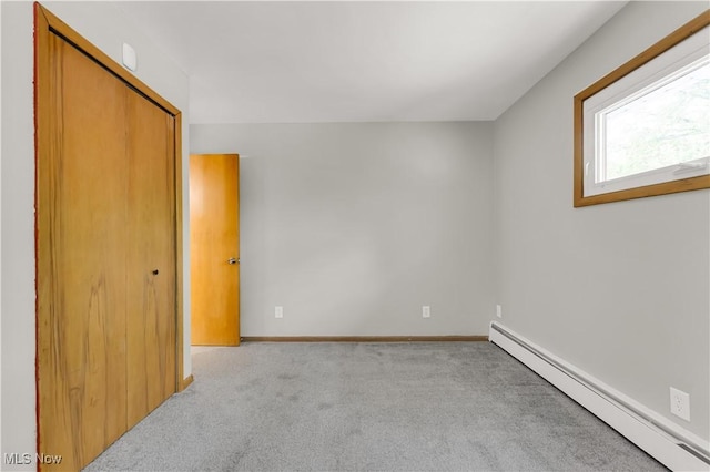 10701 Mountview Ave, Garfield Heights, OH 44125 - unfurnished bedroom featuring baseboard heating, carpet floors, a closet, and baseboards