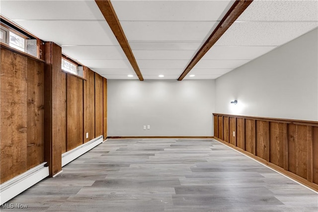 10701 Mountview Ave, Garfield Heights, OH 44125 - basement with a baseboard heating unit, wood walls, baseboard heating, light wood-type flooring, and recessed lighting