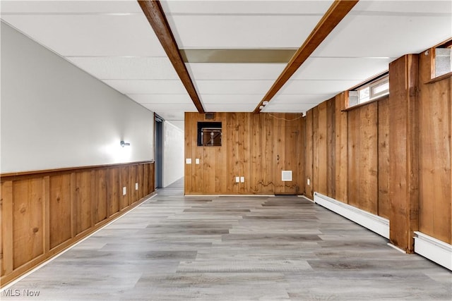 10701 Mountview Ave, Garfield Heights, OH 44125 - below grade area featuring wooden walls, a baseboard radiator, and light wood finished floors