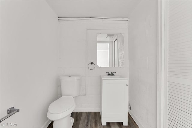 10701 Mountview Ave, Garfield Heights, OH 44125 - half bathroom with toilet, vanity, and wood finished floors