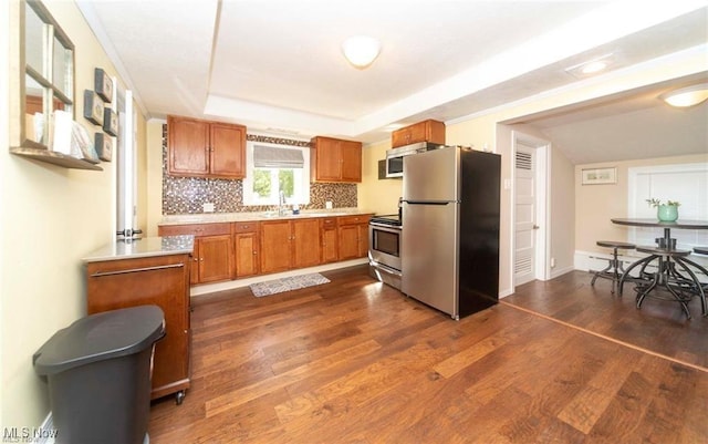 410 E Main St, Lakeside-Marblehead, OH 43440 - kitchen featuring appliances with stainless steel finishes, light countertops, a sink, brown cabinetry, and dark wood finished floors