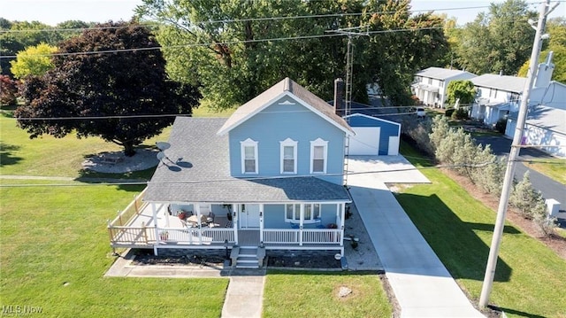 410 E Main St, Lakeside-Marblehead, OH 43440 - view of front facade with a porch, a front yard, and roof with shingles