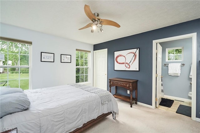 1917 Northgate Cir, Akron, OH 44320 - bedroom featuring carpet floors, baseboards, a ceiling fan, and ensuite bath