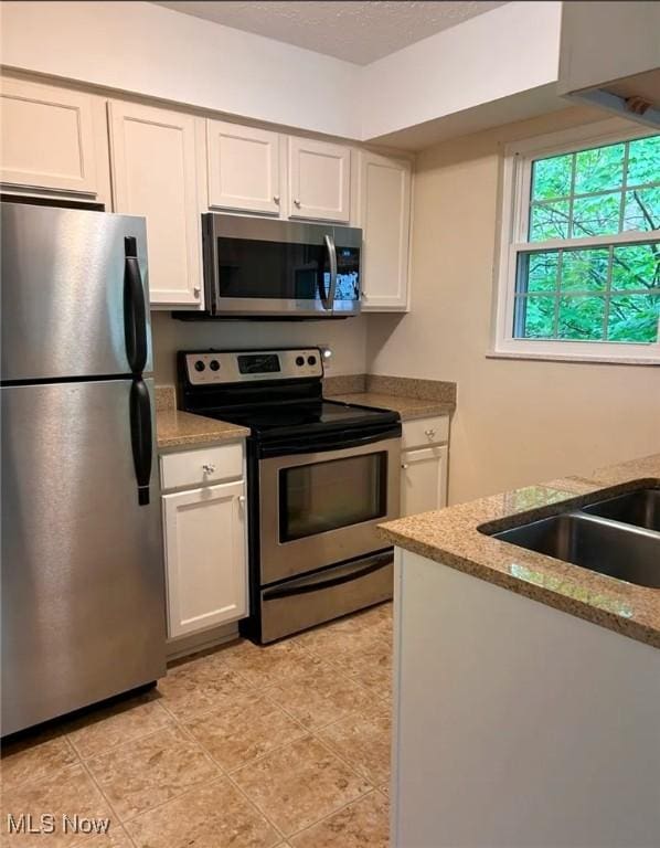 1808 Stoney Run Cir, Broadview Heights, OH 44147 - kitchen featuring stainless steel appliances, white cabinets, light stone countertops, and light tile patterned floors
