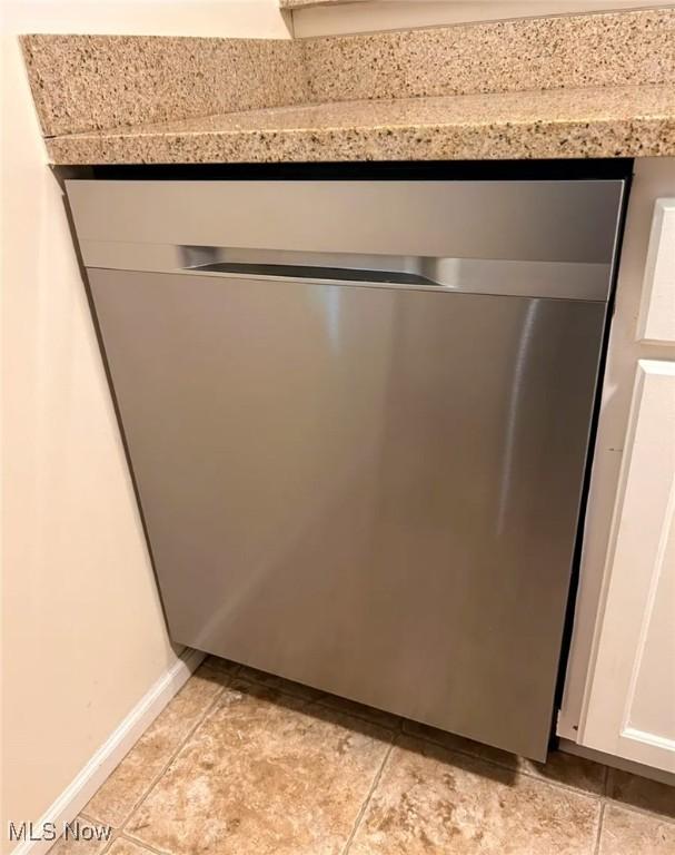 1808 Stoney Run Cir, Broadview Heights, OH 44147 - kitchen view of dishwasher, light countertops, white cabinetry, and baseboards