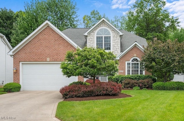4819 Trails End Ct, Westlake, OH 44145 - traditional home featuring driveway, brick siding, a garage, a front yard, and stone siding