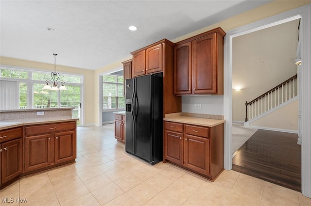 4819 Trails End Ct, Westlake, OH 44145 - kitchen with black fridge, light countertops, baseboards, decorative light fixtures, and recessed lighting