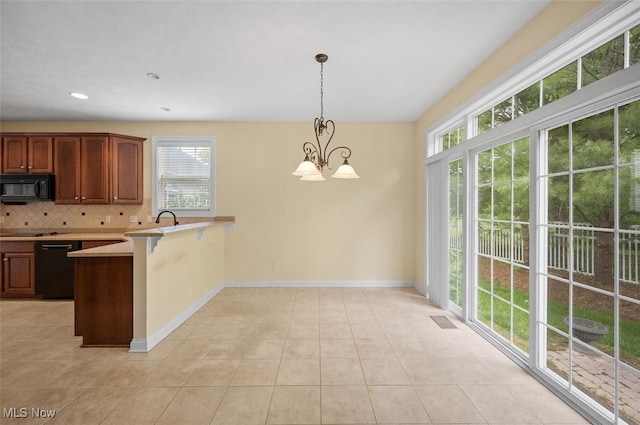 4819 Trails End Ct, Westlake, OH 44145 - kitchen with black appliances, plenty of natural light, a peninsula, tasteful backsplash, and recessed lighting