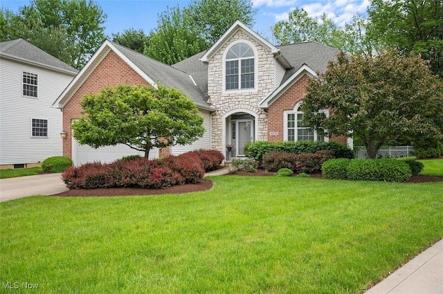 4819 Trails End Ct, Westlake, OH 44145 - traditional-style house featuring stone siding, a front yard, concrete driveway, and roof with shingles