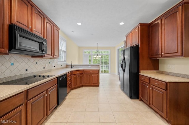 4819 Trails End Ct, Westlake, OH 44145 - kitchen with black appliances, a peninsula, a chandelier, tasteful backsplash, and a sink